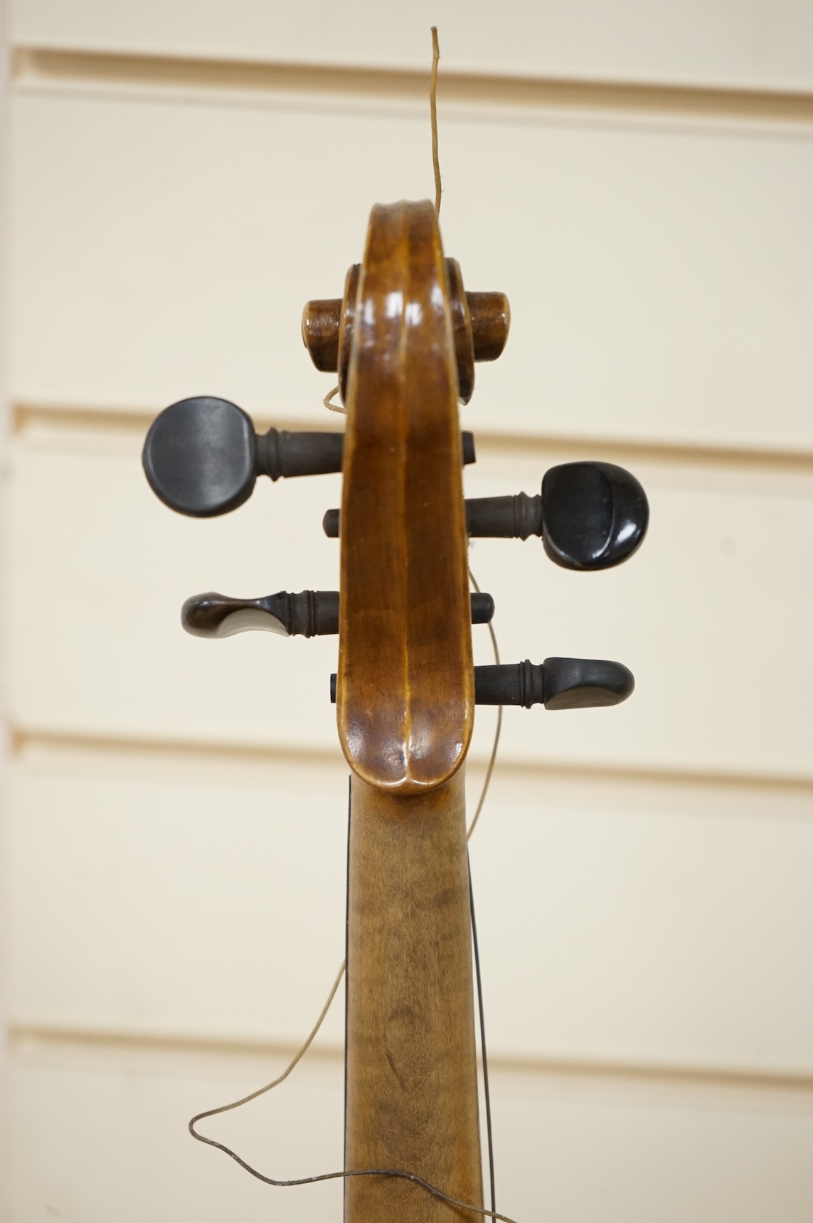 Three cased violins; a German Dresden violin, supplied by Campbell and co., Glasgow, together with another Dresden Stradivarius copy, and the remains of a European violin.
